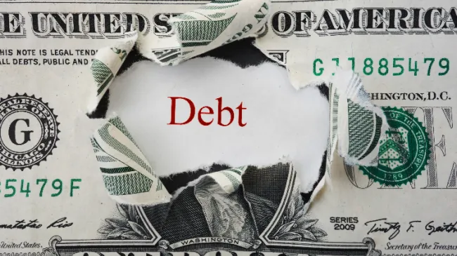 dollar bill with debt
